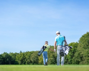adult and child golfing